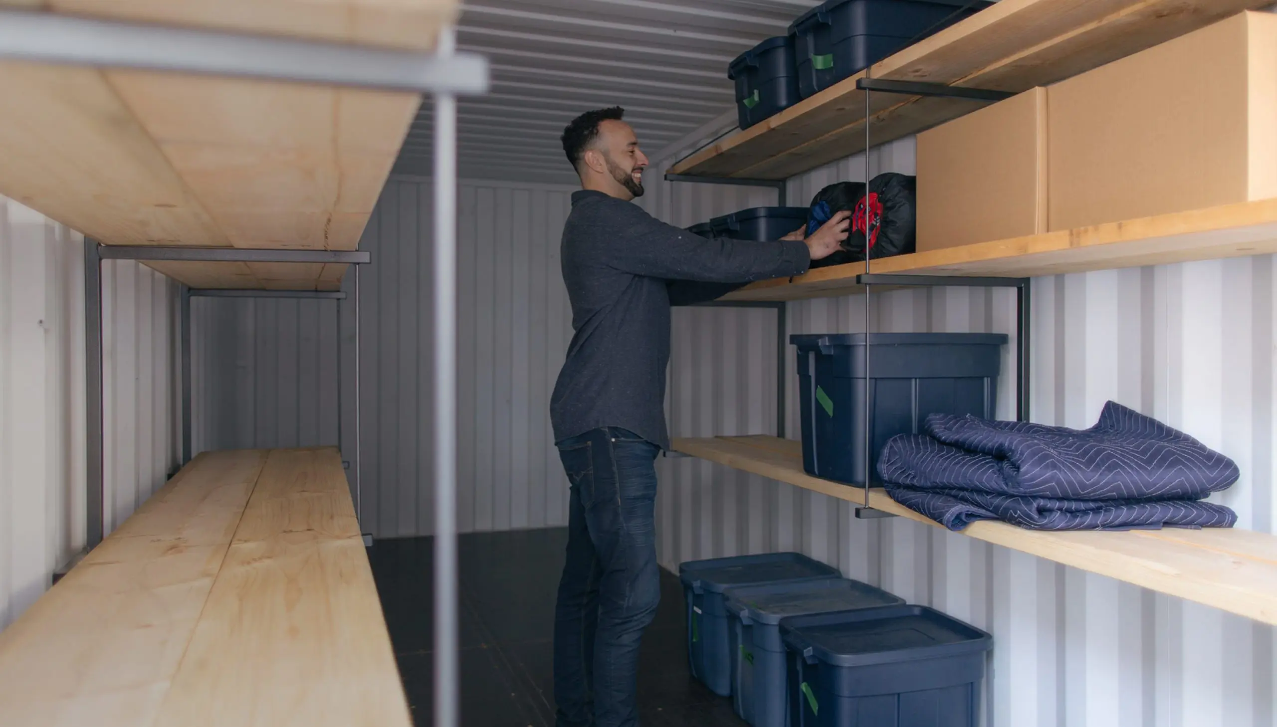 Man loading a BigSteelBox portable storage container