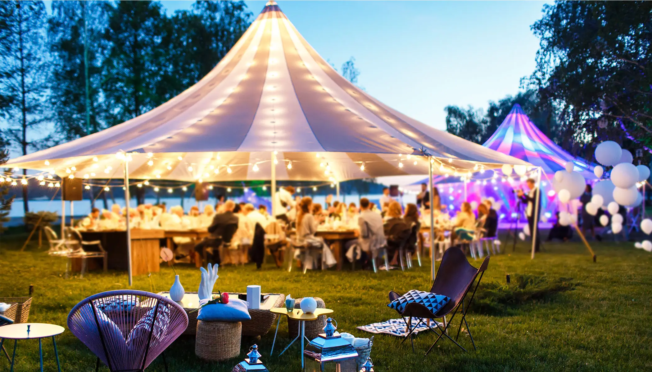 Tent and guests at an outdoor event.